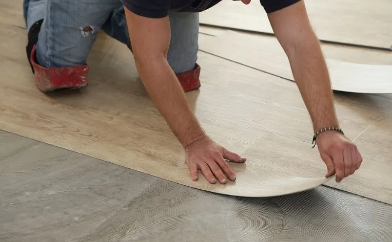 a pair of people's hands on a wooden board